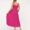 Pink maxi dress with smocked bodice and wide straps, perfect for summer or beach wear.