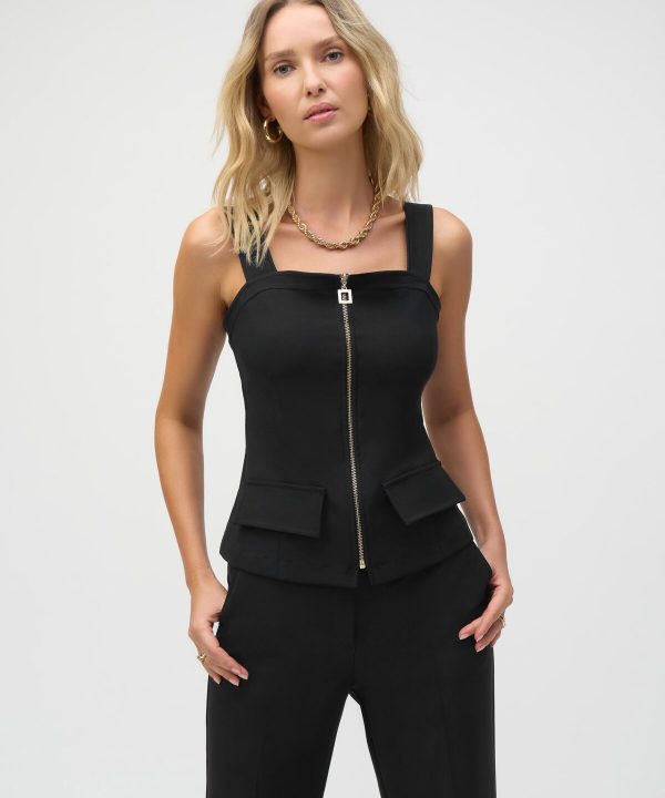Black stylish sleeveless top with front zipper and patch pockets, paired with elegant black pants, perfect for modern fashion and versatile wear.