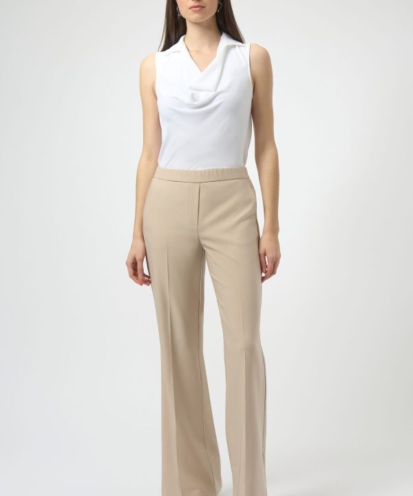 Elegant white sleeveless blouse with draped neckline, paired with beige wide-leg tailored pants—perfect for sophisticated office wear or chic casual outfits.