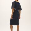 Elegant navy blue midi dress with sheer flutter sleeves, perfect for formal events or evening wear, showcased by a model with statement earrings and strappy heels.