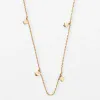 Delicate gold necklace with small clover-shaped charms, perfect for stacking or elegant everyday wear.