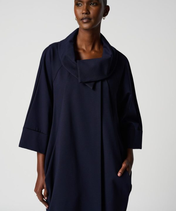 Elegant navy blue designer coat with a draped collar, perfect for stylish winter or fall outfits. Features a relaxed fit and sophisticated silhouette, ideal for modern, minimalist fashion.