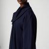 Elegant navy blue coat with a wide collar, designed for modern fashion styling, perfect for professional or casual wear.