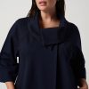 Elegant navy blue A-line dress with a statement cowl neckline, long sleeves, and modern minimalist design, perfect for sophisticated fashion styling.