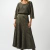 Luxurious olive green textured midi skirt and matching loose-fit top with leaf pattern, stylish fashion ensemble perfect for contemporary women's wear.
