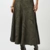 Elegant botanical-print maxi skirt in olive green, styled with knee-high dark leather boots for a chic, sophisticated look. Perfect for fashion-forward outfits and outdoor events.
