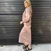 Comfy casual outfit featuring cozy blush sweatshirt and matching maxi skirt with black platform sandals against a modern black metal wall.