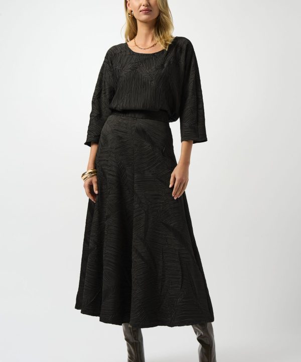 Black textured midi skirt and matching top with abstract pattern, stylish and elegant fashion outfit for women. Perfect for chic, modern, and sophisticated looks in fall and winter seasons.