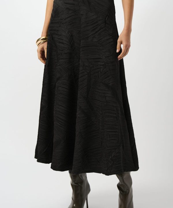 Elegant black textured midi skirt with a subtle leaf pattern, paired with knee-high heeled boots for a chic and sophisticated look, perfect for fashion-forward outfits and stylish occasions.