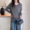Comfy gray cardigan with orange buttons and ice cream embroidery, casual street style, women's fall fashion, versatile layering piece, fashionable and cozy knitwear.