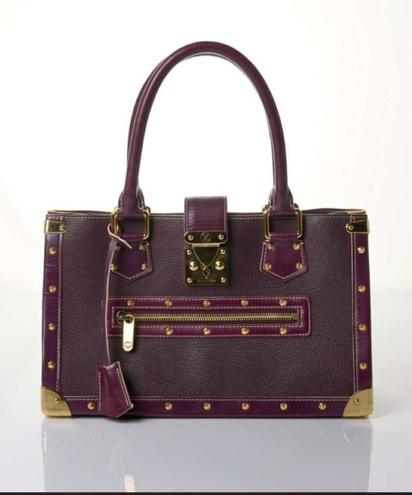 Luxurious purple leather designer handbag with gold hardware and stud accents, perfect for high-end fashion and accessories.