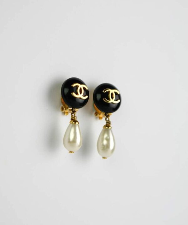 Chanel-inspired black and gold earrings with pearl drops, elegant jewelry design, luxury fashion accessories.