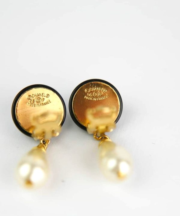 Elegant Chanel pearl earrings featuring gold accents, sophisticated jewelry designed for women, perfect for fashion-forward accessories, made in France, luxury earrings, women's jewelry.