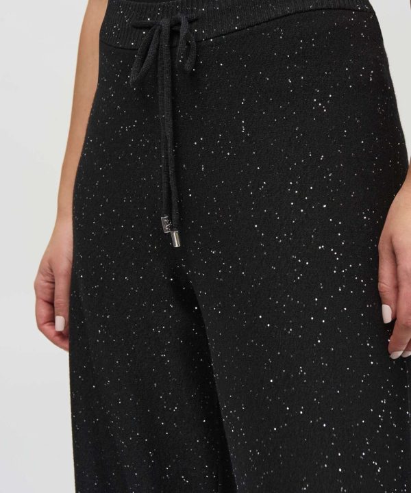 Sparkly black jogger pants with a drawstring waist and silver glitter accents, perfect for casual and stylish wear.
