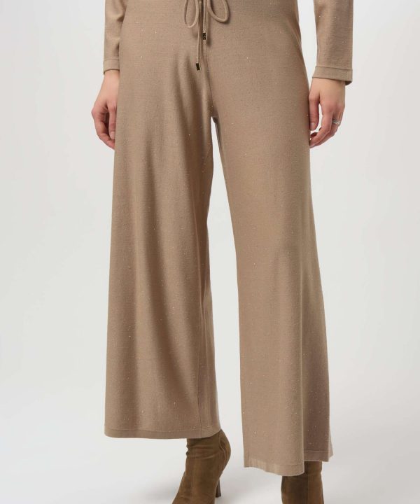 Comfortable beige wide-leg knit pants with drawstring waist, perfect for casual and chic outfits.