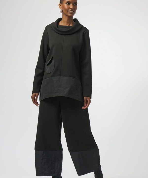 Elegant black fashion outfit featuring a modern oversized top with a cowl neckline and wide-leg pants, perfect for contemporary style and versatile for various occasions.