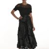 Elegant black designer outfit featuring intricate lace detailing and statement fabric textures for women’s fashion and evening wear.