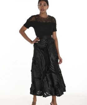 Elegant black designer outfit featuring intricate lace detailing and statement fabric textures for women’s fashion and evening wear.