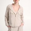 Soft beige casual hoodie and matching pants styled for comfortable fashion, featuring minimalist design, front pockets, and zip-up closure, perfect for everyday wear and relaxed outfits.