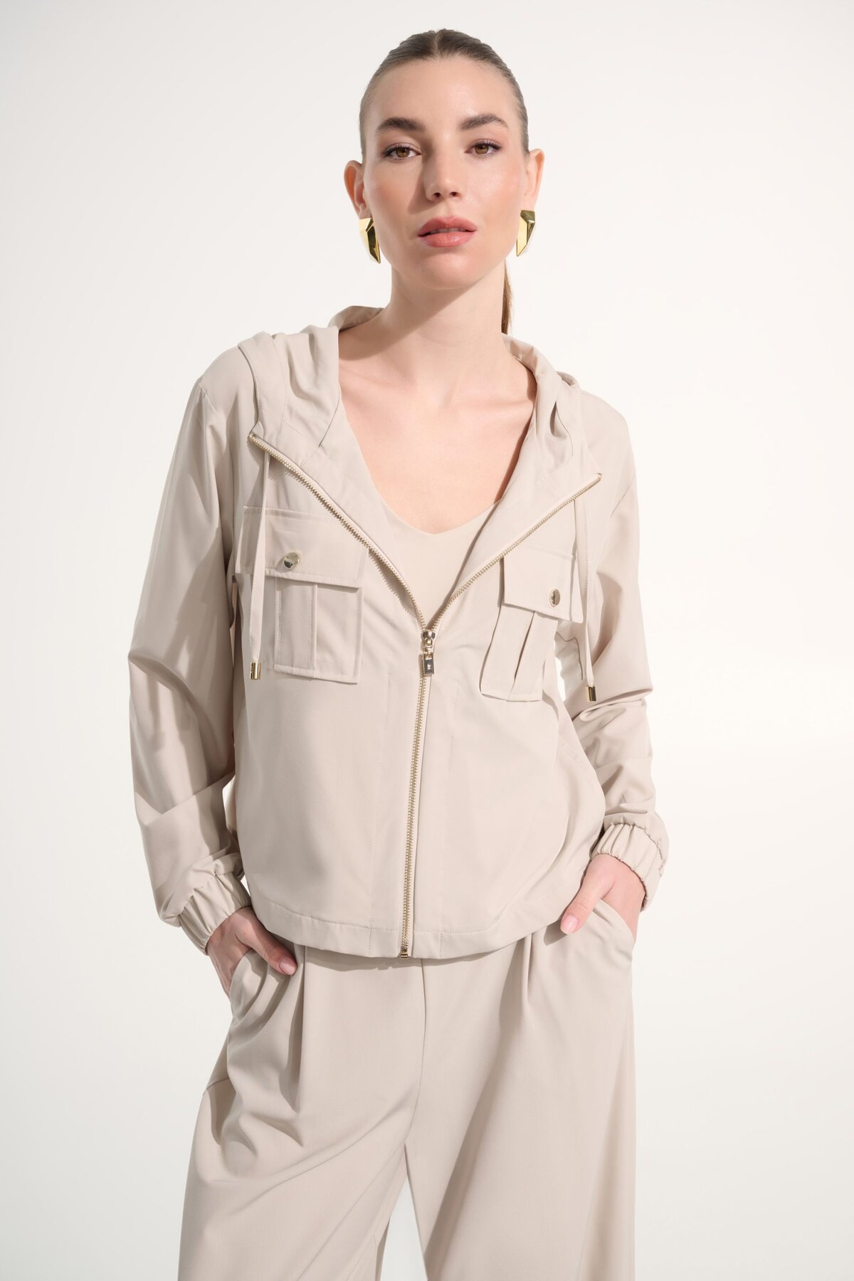 Soft beige casual hoodie and matching pants styled for comfortable fashion, featuring minimalist design, front pockets, and zip-up closure, perfect for everyday wear and relaxed outfits.