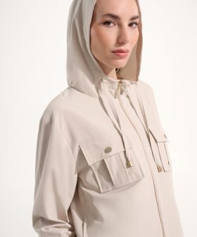 1. Women’s beige hooded jacket with front pockets, gold zipper, and adjustable drawstrings, perfect for casual and activewear.