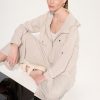 1. Minimalist beige loungewear set featuring a zip-up jacket and matching pants, styled for casual chic and comfort, perfect for modern everyday wear.