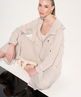 1. Minimalist beige loungewear set featuring a zip-up jacket and matching pants, styled for casual chic and comfort, perfect for modern everyday wear.
