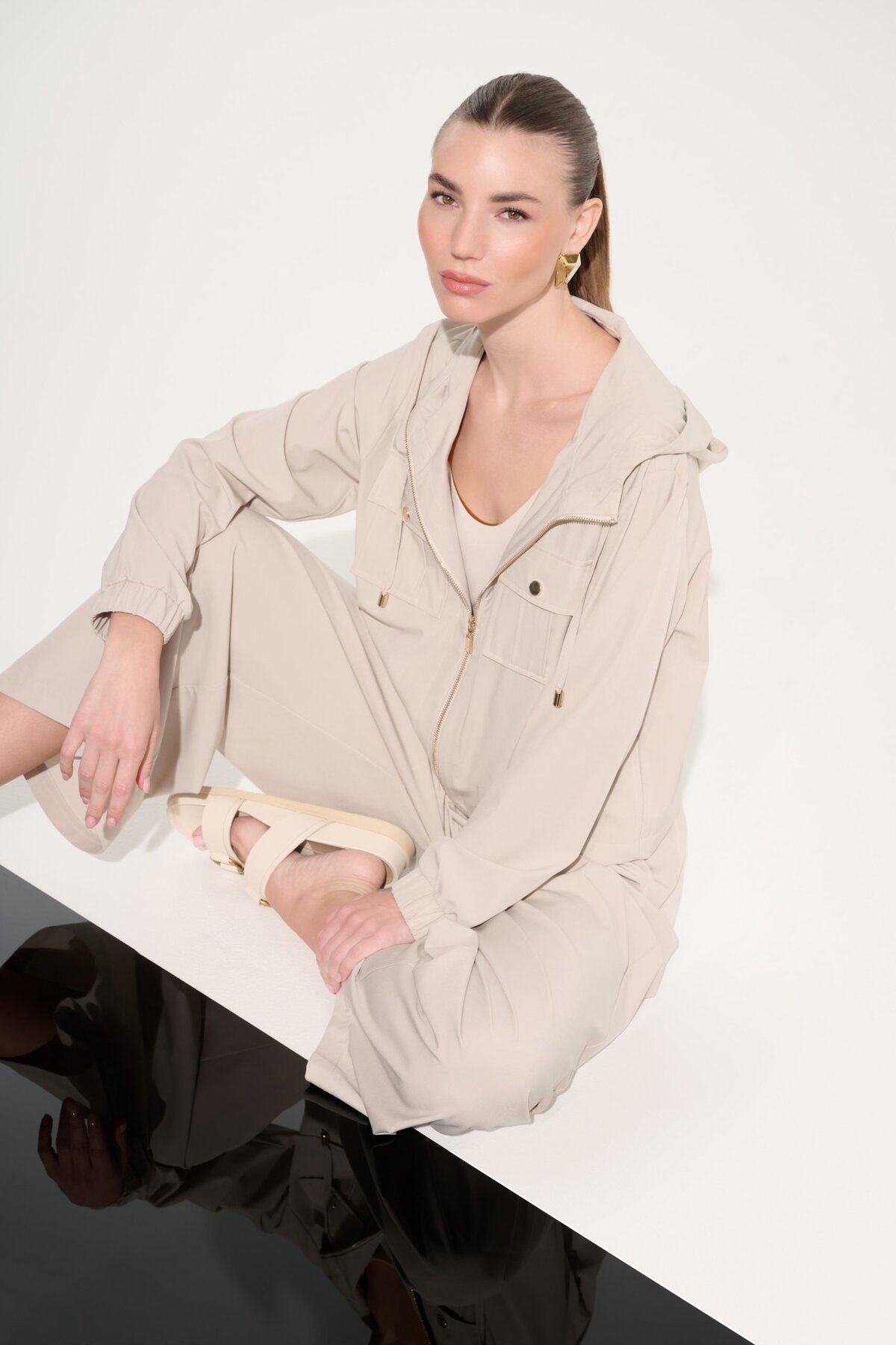 1. Minimalist beige loungewear set featuring a zip-up jacket and matching pants, styled for casual chic and comfort, perfect for modern everyday wear.
