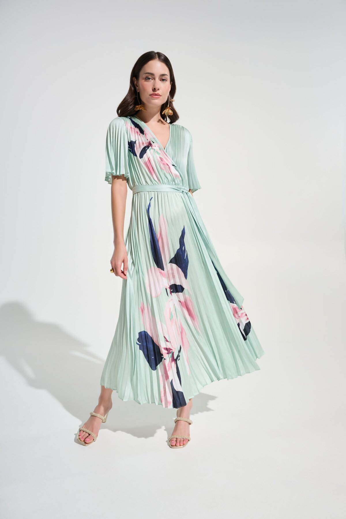 1. Elegant floral pleated dress by Katy Amaker featuring pastel colors, flowy design, and modern style perfect for spring or summer occasions.