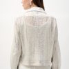 Vintage white crochet blazer with satin details, suitable for stylish casual or formal outfits, showcasing modern boho-chic fashion trends.