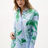 Stylish women's button-up shirt with vibrant green floral pattern and blue stripe details, perfect for fashion-forward outfits and summer wardrobe essentials.