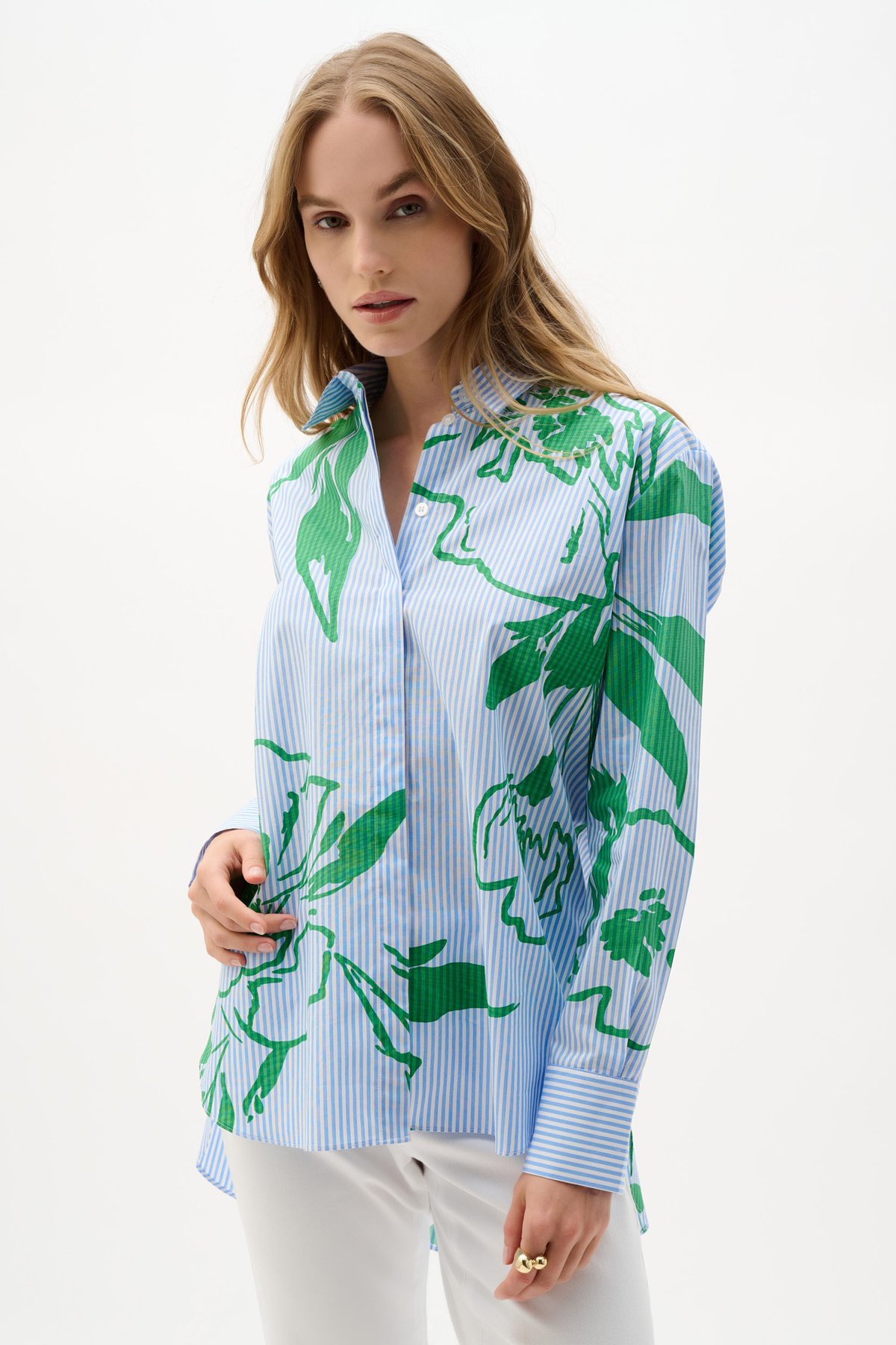 Stylish women's button-up shirt with vibrant green floral pattern and blue stripe details, perfect for fashion-forward outfits and summer wardrobe essentials.
