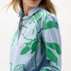 Vibrant green botanical print shirt by Katy A Maker featuring blue and white pinstripes, modern design, and stylish collar. Perfect for contemporary fashion, eco-friendly fabrics, and statement shirts.